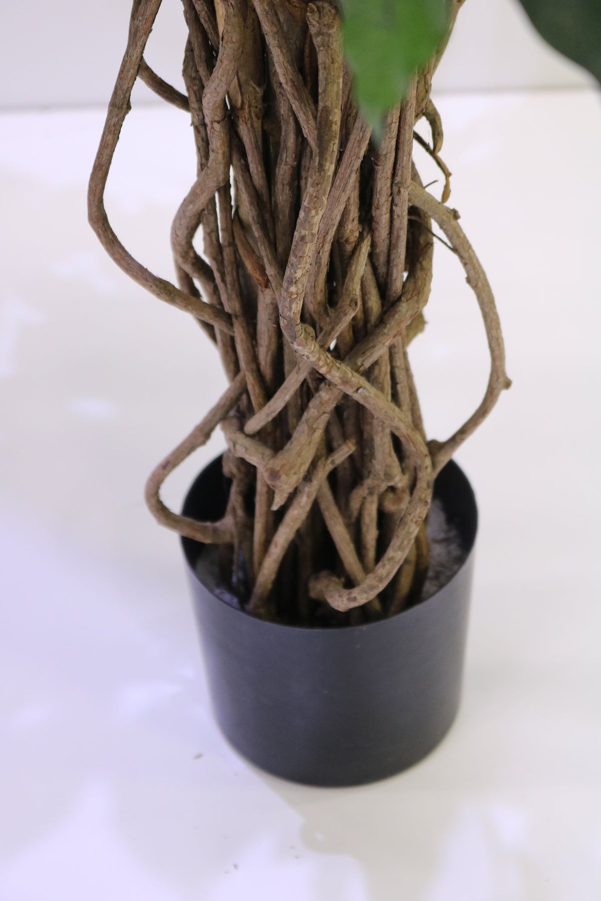 Close-up of the Ficus Liana Deluxe artificial plant stem, showcasing its realistic intertwined trunk texture and natural wood-like detailing.